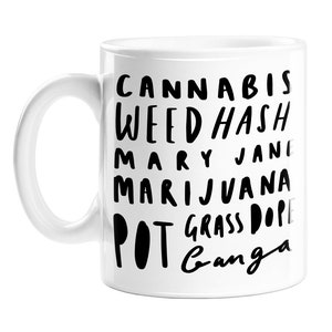 May include: White ceramic mug with black text that reads "Cannabis, Weed, Hash, Mary Jane, Marijuana, Pot, Grass, Dope, Ganga".