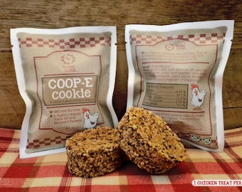 May include: A brown paper bag with a white border, labeled "COOP-E cookie" and "THYME & FORK". The bag contains a round, brown, crunchy chicken treat. The bag also includes a list of ingredients and a guaranteed analysis. The text "1 CHICKEN TREAT PER ORDER" is printed below the image.