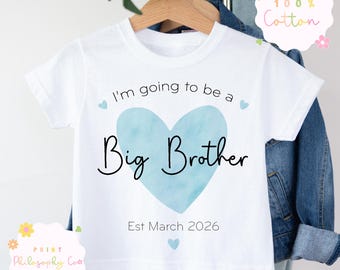May include: White t-shirt with the text "I'm going to be a Big Brother" in black script over a light blue heart. The shirt also includes the text "Est March 2026". The shirt is made of 100% cotton.
