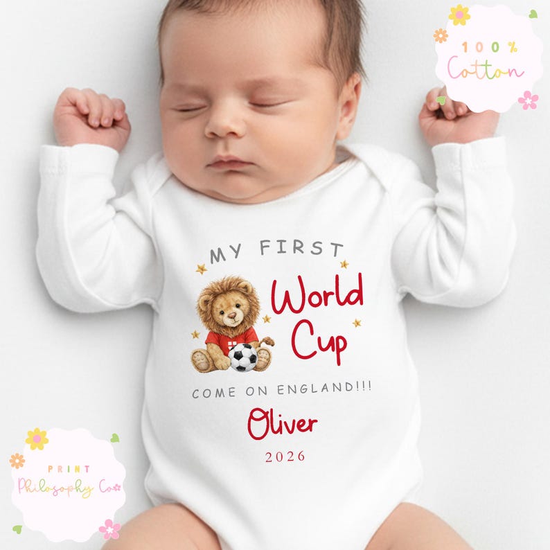 May include: White baby bodysuit with the text "MY FIRST World Cup" in red and a lion illustration. The bodysuit also includes the text "COME ON ENGLAND!!!" and the name "Oliver" with the year "2026". The bodysuit is made of 100% cotton.