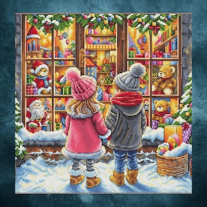 May include: A cross-stitch image depicts two children gazing at a Christmas shop window filled with toys. The window displays teddy bears, Santa Claus figures, and wrapped gifts. The children wear winter coats, hats, and boots, standing in a snowy scene.