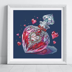 May include: A framed cross-stitch pattern featuring a faceted red heart-shaped glass bottle with a diamond-like stopper. The bottle is adorned with silver filigree and a central heart label reading Love Potion, surrounded by floating red crystal hearts.