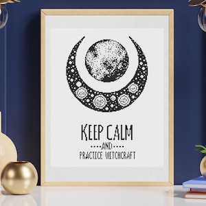 May include: Framed black and white print featuring a crescent moon and a full moon design. The text "KEEP CALM ....AND.... PRACTICE WITCHCRAFT" is below the moon graphic. The print is in a wooden frame.
