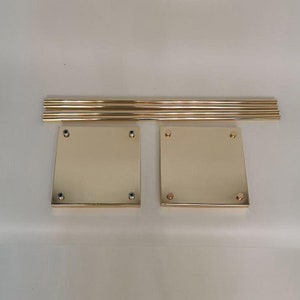 May include: Gold metal cake stand set with four round tiers and four square bases. The stand is disassembled and ready for assembly.