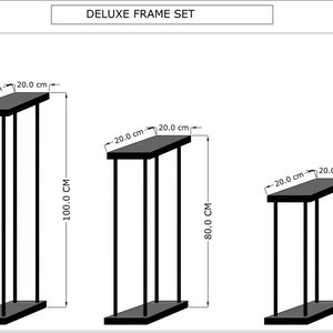 May include: A set of three black metal frames with different heights. The frames are 20 inches wide and 100, 80, and 60 inches tall.