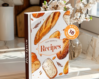 May include: A white cookbook with a brown spine. The cover features a hand-drawn illustration of various breads and the text "Our Favourite Recipes". A bonus sticker with the text "Bonus 18 Printables" is on the cover.