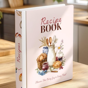 Peut inclure: Un livre de recettes rose clair avec le titre "Recipe Book" dans une police décorative. La couverture présente des illustrations de pain, d'un panier, d'un pot de confiture et d'un pichet avec des ustensiles. L'épine dorsale indique "Recettes". Le texte en bas dit "Saveurs qui apportent de la joie à chaque repas!"