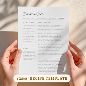 May include: A recipe template for chocolate cake, held by hands. The recipe includes ingredients and preparation steps. The text "Chocolate Cake" is at the top, with "Canva RECIPE TEMPLATE" at the bottom.