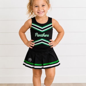 May include: A black cheerleading uniform featuring a sleeveless top with white and green chevron stripes and the word Panthers in white script. The matching pleated skirt has white and green hem stripes and a small white paw print graphic.