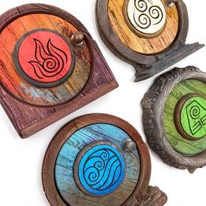 May include: Four decorative wooden door ornaments with different elemental symbols. The doors are painted in various colors, including red, blue, green, and brown, with a weathered wood grain finish. Each door has a small, round handle.
