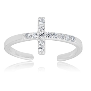 May include: A silver toe ring with a small, clear crystal cross design. The cross is set with smaller crystals.