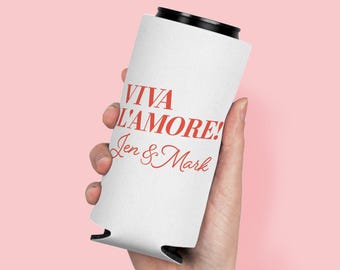 May include: A white cylindrical can cooler featuring the red text VIVA L'AMORE! followed by the names Jen & Mark in a red cursive script. The sleeve has a black rim at the top and bottom, designed to hold a standard beverage can securely.