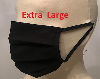 May include: Black face mask with elastic ear loops. The mask is pleated and has the text "Extra Large" printed on it.