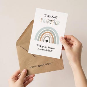 May include: A greeting card with the text "To The Best Instructor" and a rainbow design in muted colors. The card is held in a brown envelope. The text "Thank you for believing in me when I didn't" is also on the card.