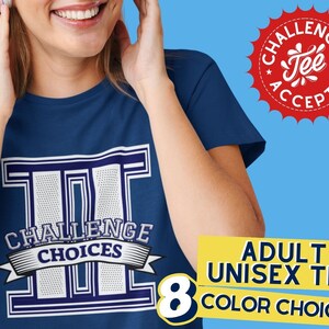May include: A blue t-shirt with a white graphic of the letters "III" with the words "Challenge Choices" printed below. The shirt is available in 8 colors. The image also includes a red starburst with the words "Challenge Tee Accepted" printed inside.
