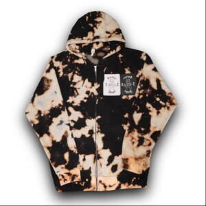 May include: Black and white tie-dye zip-up hoodie with a patch on the front that says "Torture Angel" and "Killing Angels".