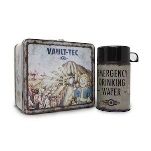 May include: A metal lunchbox and a travel mug. The lunchbox has a distressed finish and features the text "VAULT-TEC" and a cartoon illustration. The mug reads "EMERGENCY DRINKING WATER" and has a black lid.