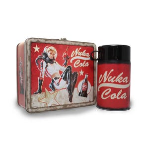 May include: A red and white Nuka Cola lunchbox and thermos set. The lunchbox features a retro pin-up girl in a space suit with the Nuka Cola logo. The thermos is red with the Nuka Cola logo and a black lid.