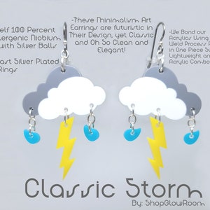 May include: A pair of silver earrings featuring a white cloud with a gray top, a yellow lightning bolt, and three blue raindrops. The earrings are made of acrylic and are lightweight and strong. "Classic Storm" is written below the earrings. "By: ShopGlowRoom" is written below the text.