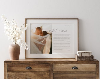 May include: A framed wedding print with a photo of a couple kissing. The text below the photo reads "rachel + isaac" and includes the date "27 September 2021".