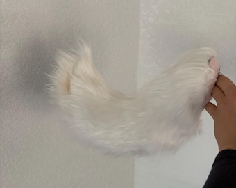 white curled wagging belt loop tail