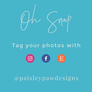 May include: A blue background with white text that says "Oh Snap" and "Tag your photos with" followed by three social media icons: Instagram, Facebook, and Etsy. The text below the icons says "@paisleypawdesigns".