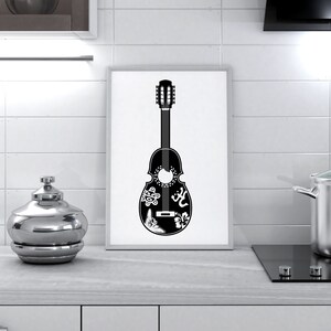 May include: A black and white illustration of a guitar with intricate designs, including a flower, a bird, and a symbol. The guitar is framed and hanging on a white tiled wall.