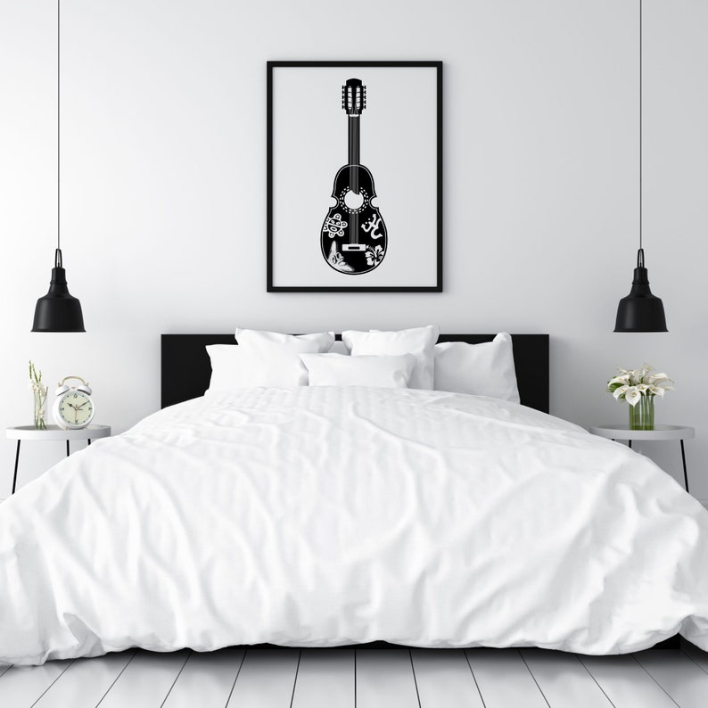 May include: A black and white illustration of a guitar with intricate designs on the body. The guitar is hanging on a white wall above a white bed with black bedding.