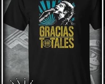 May include: Black t-shirt with a blue and yellow graphic of a person singing with the text "GRACIAS TOTALES" on the front.