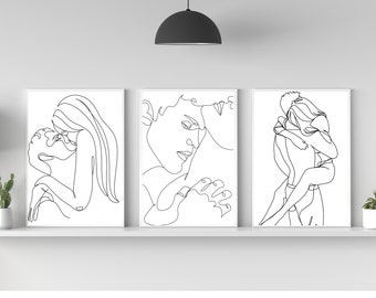 Puede incluir: Tres impresiones en blanco y negro de parejas abrazándose, realizadas con líneas. Las impresiones están enmarcadas en blanco y se muestran en un estante blanco.