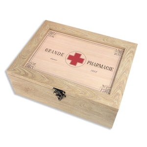 May include: A wooden first aid box with a red cross and the text "GRANDE PHARMAGIE 1868" on the lid.