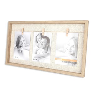 May include: A light-colored wooden picture frame with three photos clipped to a string. The photos are black and white and feature people. The frame has a textured background and is labeled "10 x 15" on the photos.