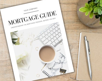 May include: A white guide with the text "MORTGAGE GUIDE" and "UNDERSTANDING THE MORTGAGE PROCESS. BEFORE YOU BUY" in black text. The guide is on a wooden table with a white keyboard, a cup of coffee, a notebook, a pen, and white flowers.