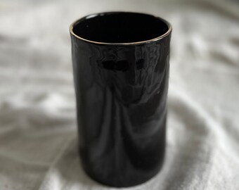 Black vase with gold accents
