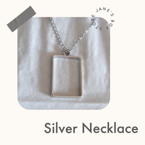 The 1975 inspired Silver rectangle box necklace.