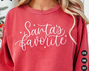 May include: Red sweatshirt with white text that says "Santa's Favourite".