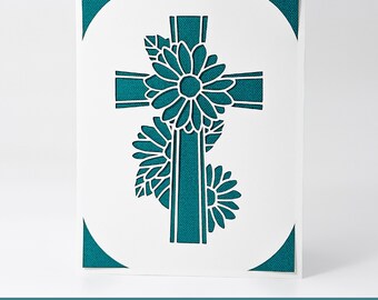 May include: A white card with a teal blue cross and floral design. The text "GlamSVG+" and "INSERT CARD FOR CRICUT CARD MATS & STANDARD MATS ::: SVG / DXF / EPS" is at the bottom of the card.