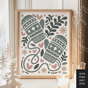 May include: A framed print with a winter design. It features two green mittens with star and dot patterns, alongside pink hearts and floral elements. The artwork evokes a cosy, festive atmosphere, perfect for seasonal decor. The frame is made of wood.