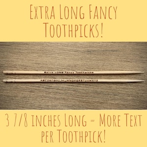 May include: Two wooden toothpicks with the text "Extra LONG Fancy Toothpicks" and the alphabet printed on them. The toothpicks are 3 7/8 inches long.