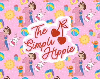 May include: Pink patterned fabric featuring repeating illustrations of a girl holding a number one, a smiling sun, a bunny, a toy block, a beach ball, and a character. The text "The Simple Hippie" is in the center.