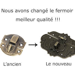 May include: A side-by-side comparison of two antique-style brass clasps. The clasp on the left is simple and round, while the clasp on the right is ornate and features a floral design. The text "Nous avons chang&eacute; le fermoir meilleur qualit&eacute;!!!" is written above the clasps. The text "L'ancien" is written below the left clasp and "Le nouveau" is written below the right clasp.
