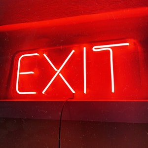May include: A red neon sign with the word "EXIT" in white neon lettering.