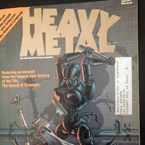 May include: A cover of Heavy Metal magazine featuring a black and silver robot wielding a wrench and attacking a smaller, defeated robot. The cover text reads "Heavy Metal" and "The adult illustrated fantasy magazine". The magazine is from April 1977 and costs $1.50.