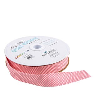May include: A spool of single-fold quilt binding tape featuring a pink and white gingham check pattern. The white label on the spool displays the text Single-Fold Quilt Binding, 2.5 inch bias tape, Riley Blake Designs, and Peony color name.