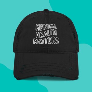Front view of Mental Health Matters embroidered on a black distressed dad hat