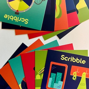May include: A collection of colorful cards with illustrations and the word "Scribble." The cards feature various designs, including a colorful wheel, a cityscape, and abstract shapes. The cards are fanned out, showcasing their vibrant colors and playful themes.
