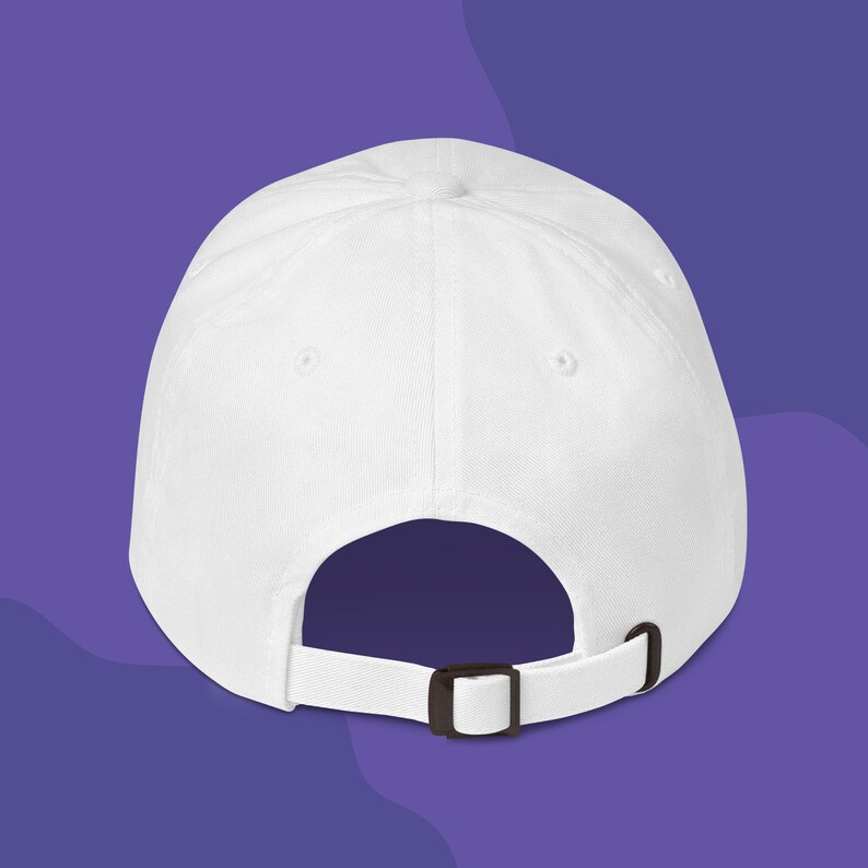 The back of a white dad hat to show the adjustable strap.
