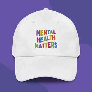 White dad hat with Mental Health Matters embroidered in colorful letters.