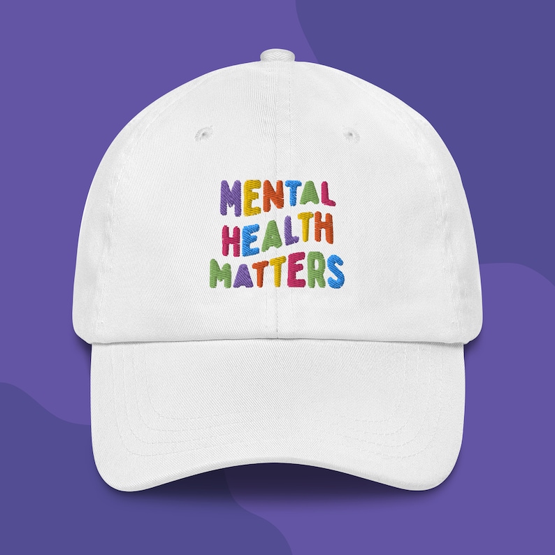 White dad hat with Mental Health Matters embroidered in colorful letters.
