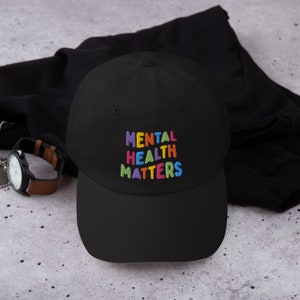 Black dad hat with Mental Health Matters embroidered in colorful letters.